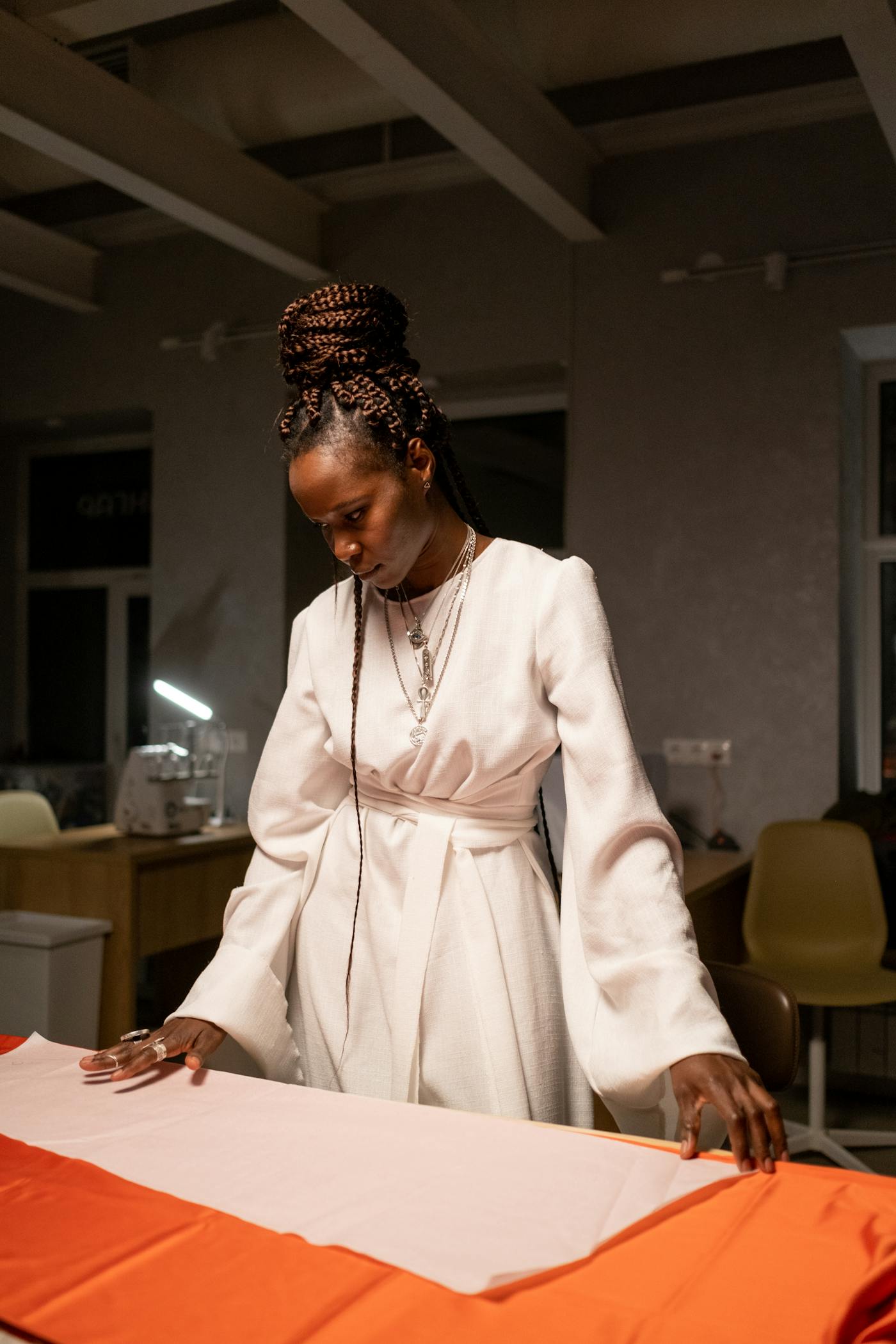 Fashion designer reviewing fabric and development details in studio